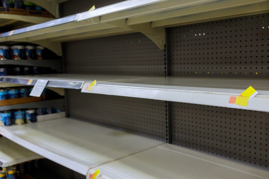 Grocery store with empty shelves for goods during the Coronavirus COVID-19 pandemic in a supermarket